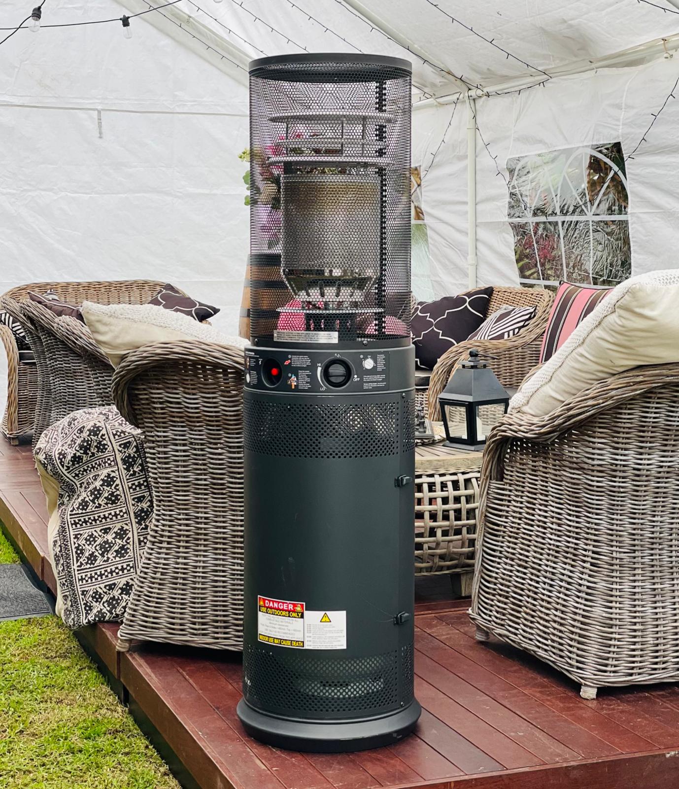 A gas heater sitting on a deck.