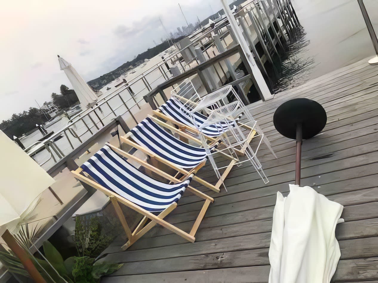 A deck chair and umbrella on a dock hired from Party Hire Group