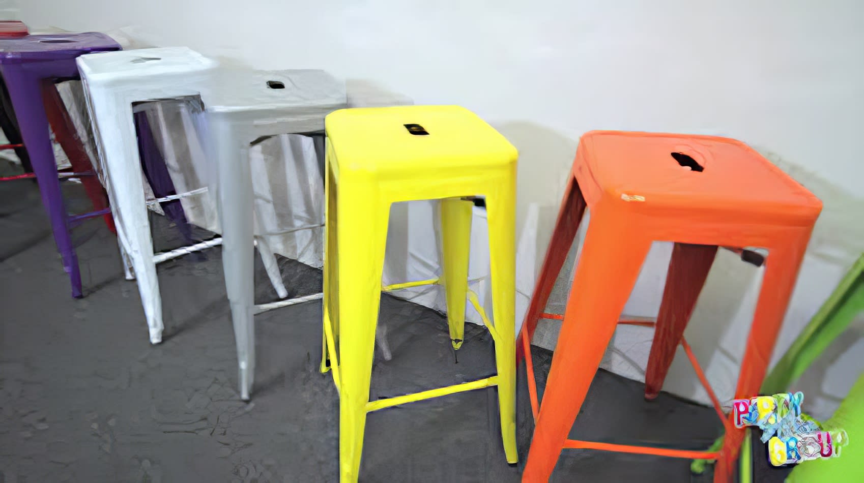 A row of vibrant yellow Tolix stools.