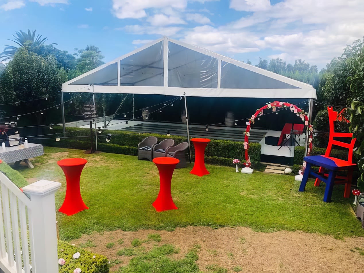 A party tent set up in a backyard using our red Lycra Socks