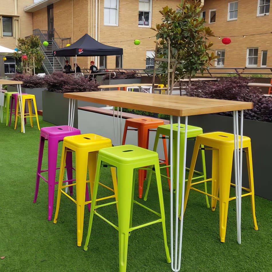 Vibrantly hued Lime Tolix Stool Hire set up on a grassy area.