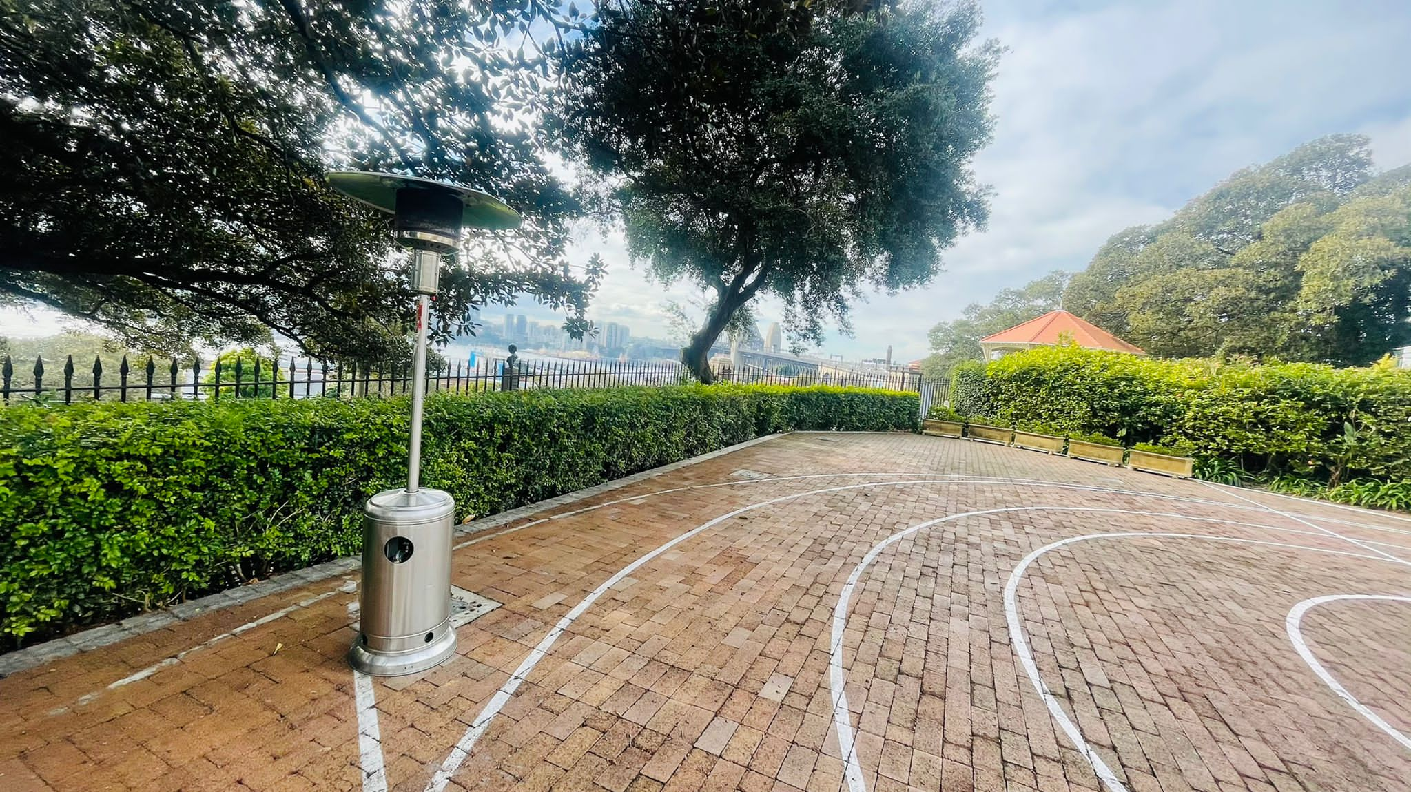 A brick walkway with a white track in the middle, decorated with two Mushroom Heaters.