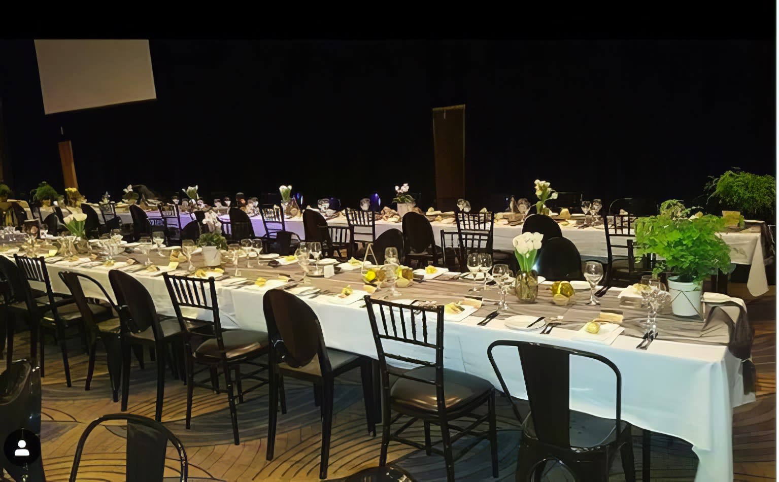 A long table set up for a formal dinner featuring Black Victorian Chairs.