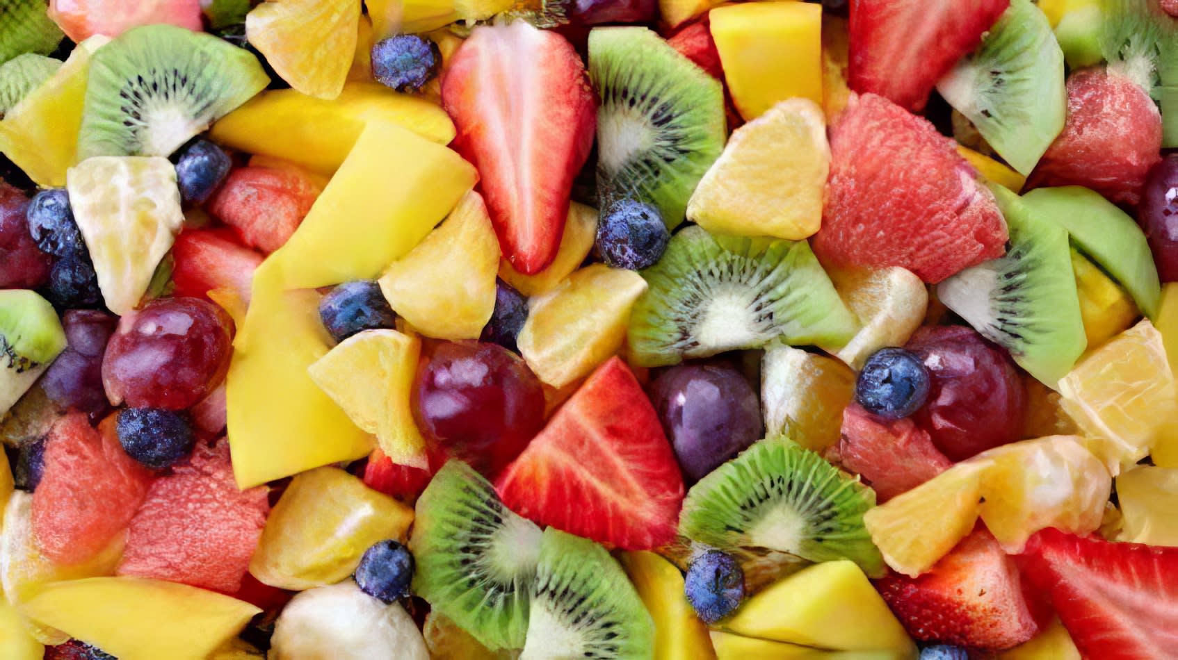 A vibrant display of medium-sized fruit platter, showcasing in-season fruits, presented in a bowl.