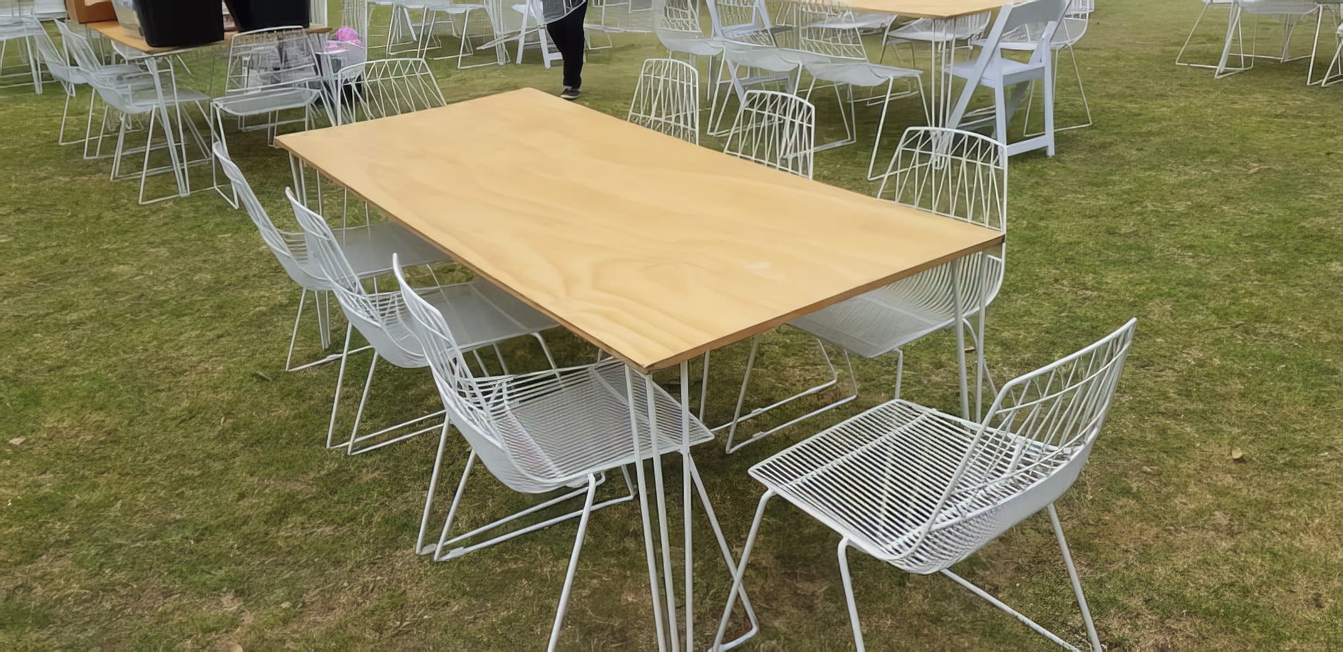 A white table on a grassy field