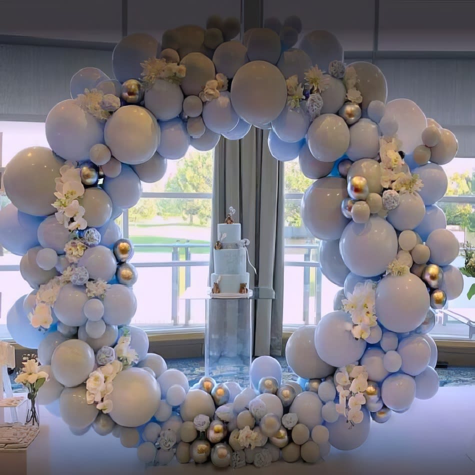 A balloon arch decorated with white balloons resembles a beautiful white hoop backdrop.