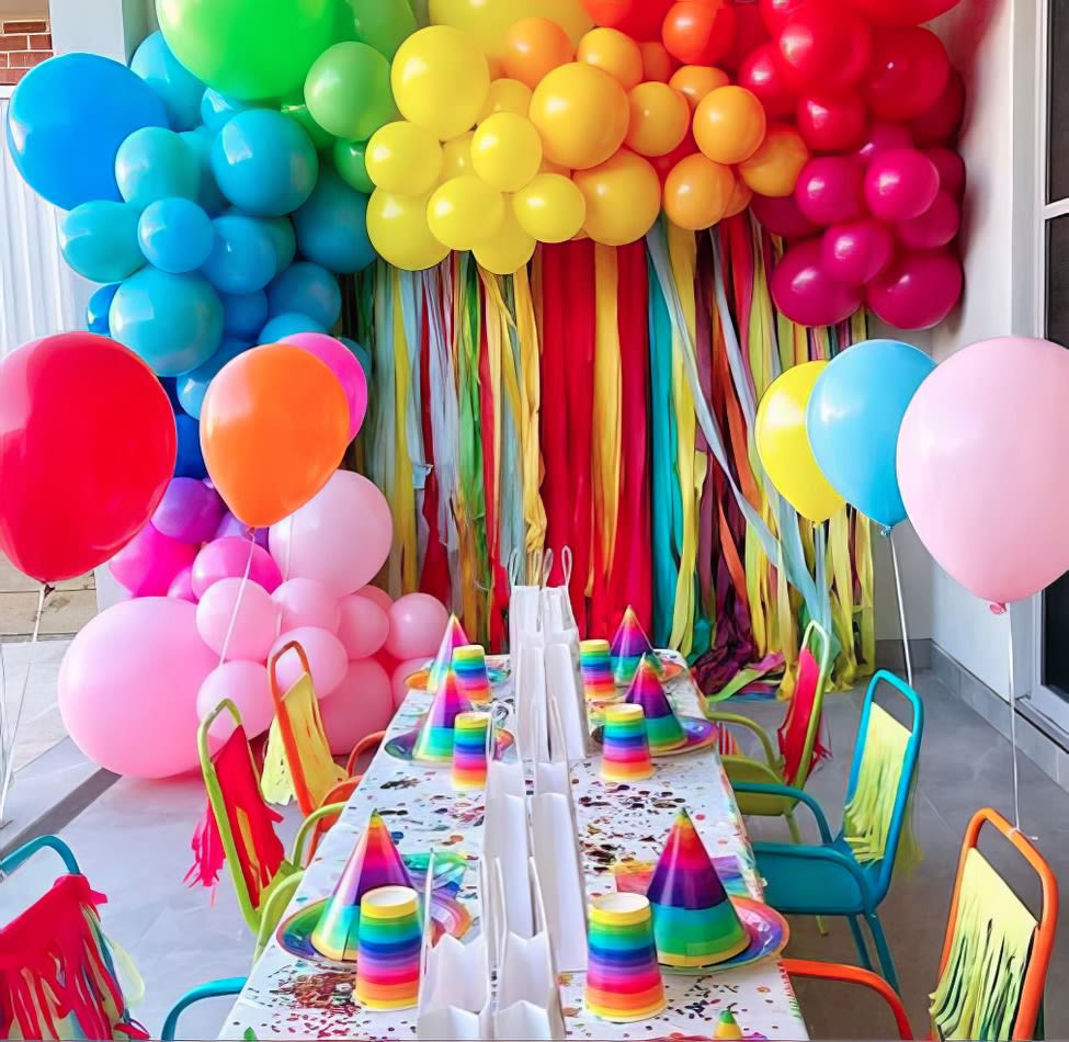 A vibrant birthday party set up with balloons, decorations, and Kids Mesh Chair Hire.