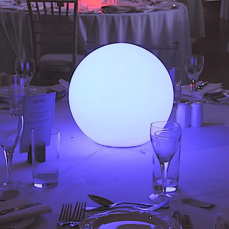 A table is set up with a blue Glow Sphere Hire ball