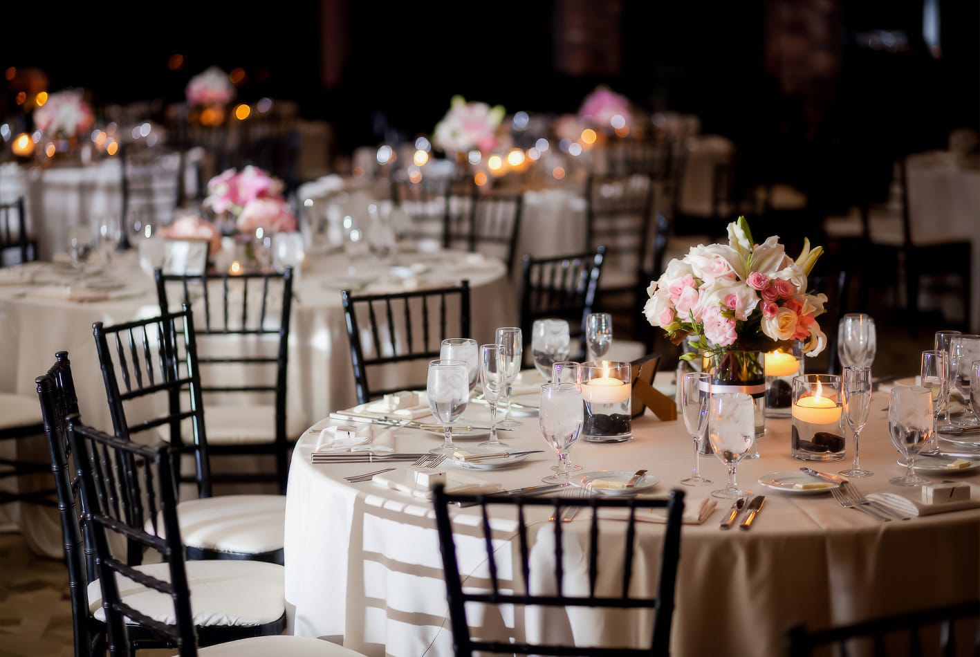 Round black and white plastic tablecloths for banquet tables.