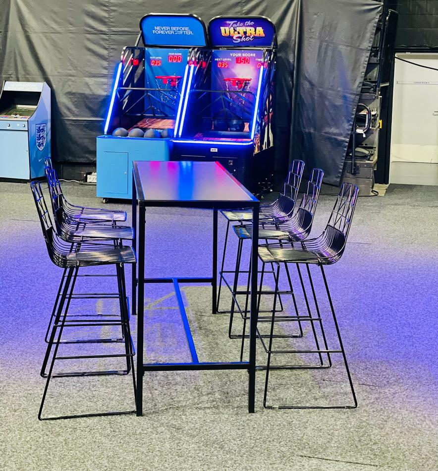 A table with chairs and a Black Arrow Stool.