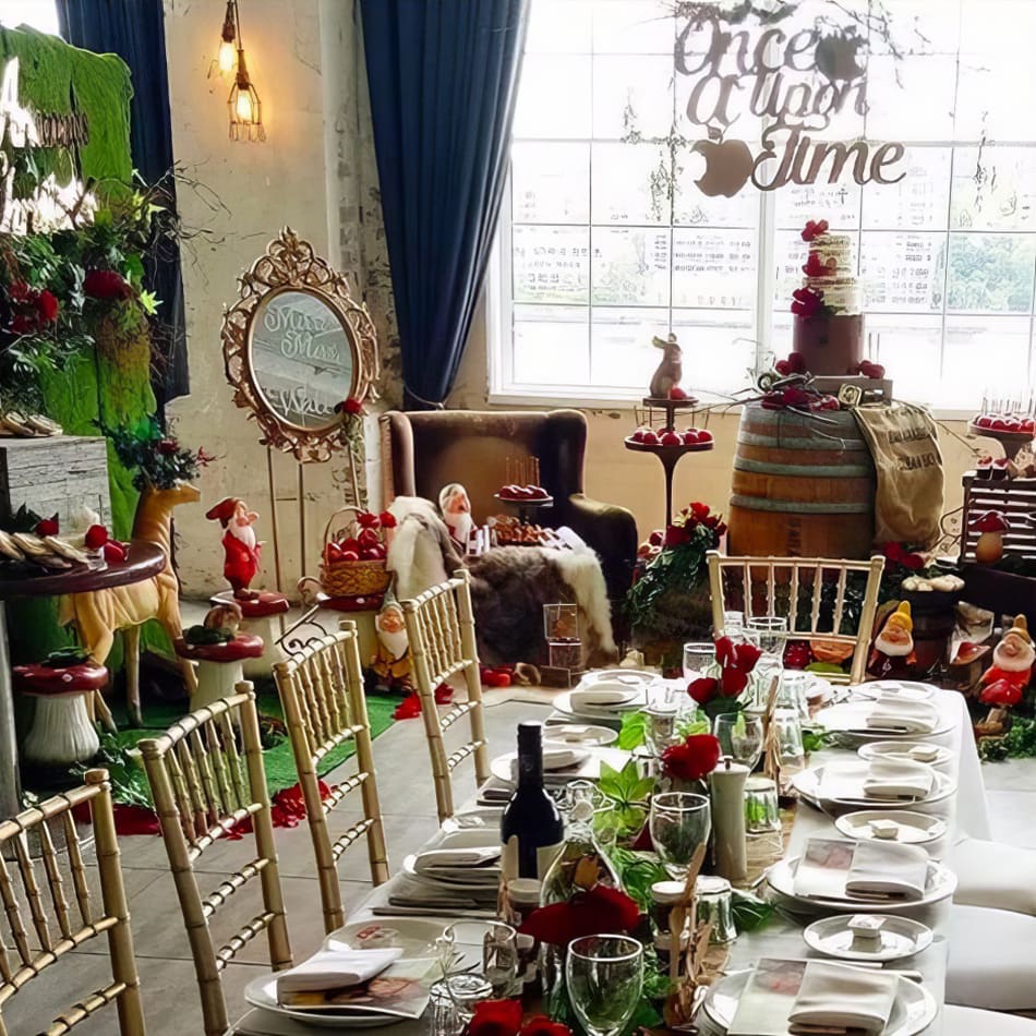 A table set up for a party with a lot of decorations and elegant gold Tiffany chair hire.