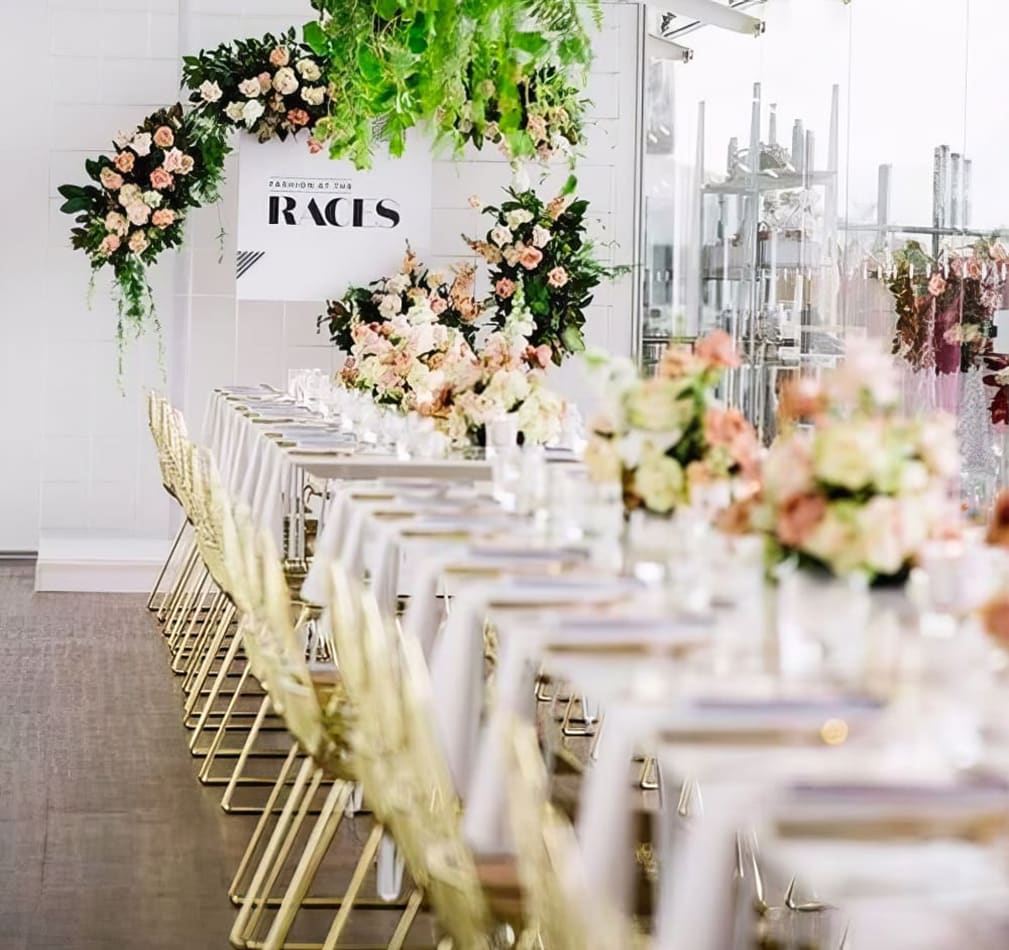 A beautifully decorated wedding reception table adorned with flowers and a sign.