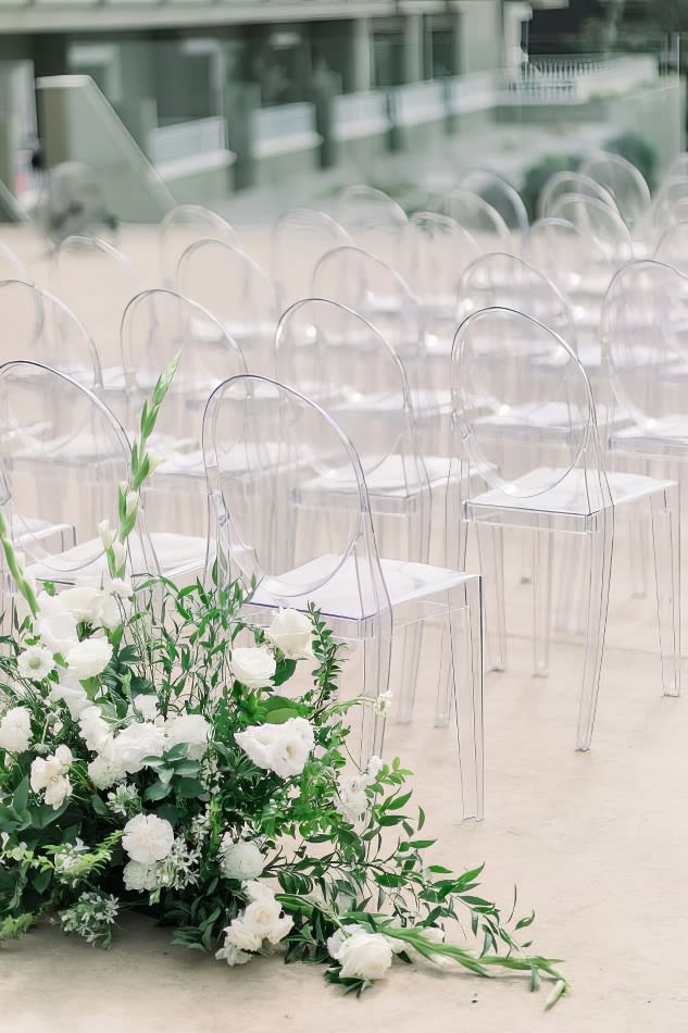 A white wedding ceremony with Victorian Ghost Chair Hire and white flowers.