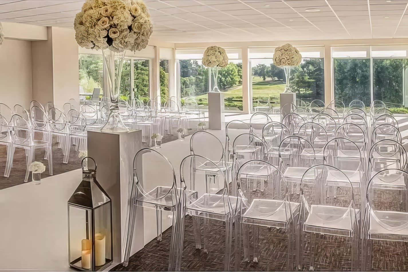 A Victorian ghost chair hire for an elegant wedding ceremony, adorned with beautiful flowers.