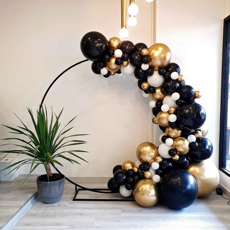 A black hoop balloon arch in a room.