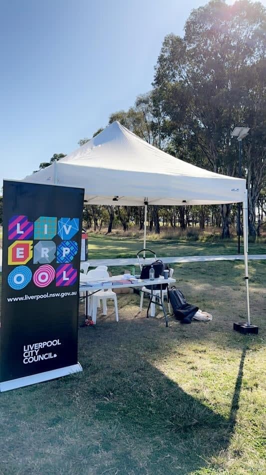 A 3mx3m pop-up marquee with a white roof set up in a grassy area.