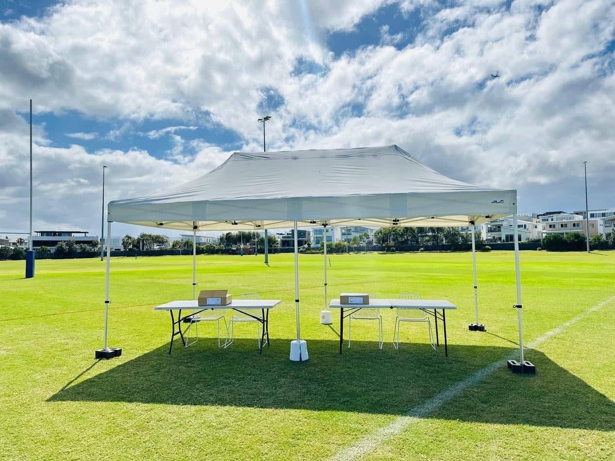 A 3mx6m pop-up marquee with a white roof set up on a grassy field.