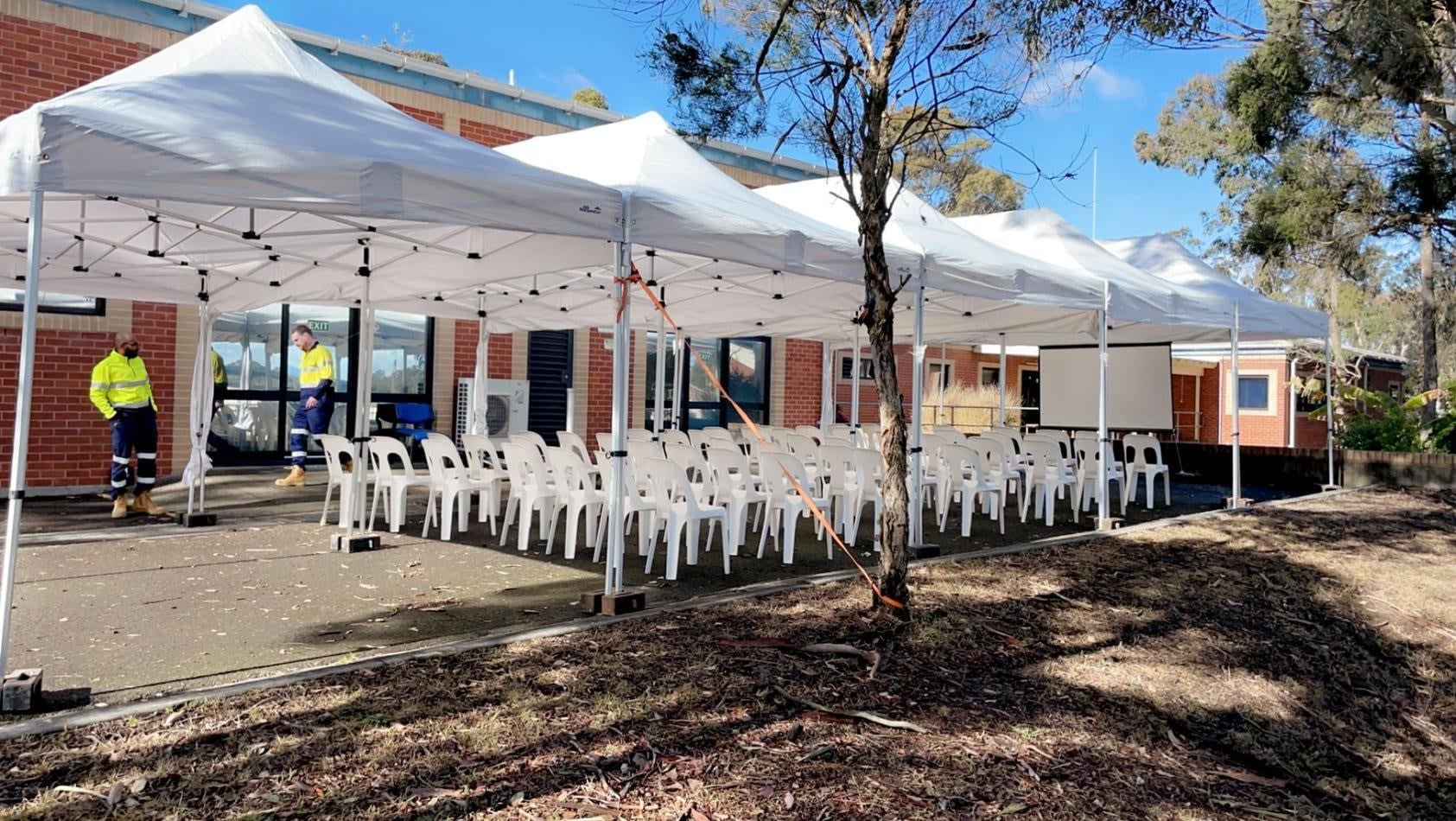 A 3mx6m white tent, also known as a pop-up marquee with a white roof, set up in front of a building.