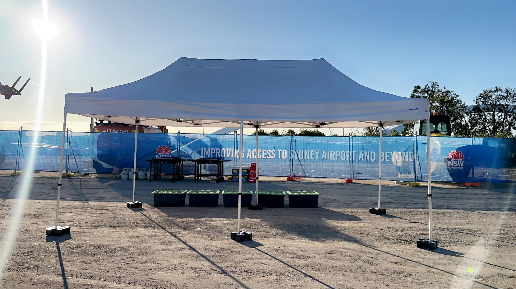 A 3mx6m pop up marquee with a white roof, set up in front of a construction site.