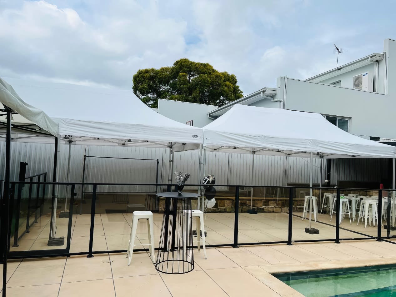 A 3mx6m pop-up marquee with a white roof stands next to a swimming pool.