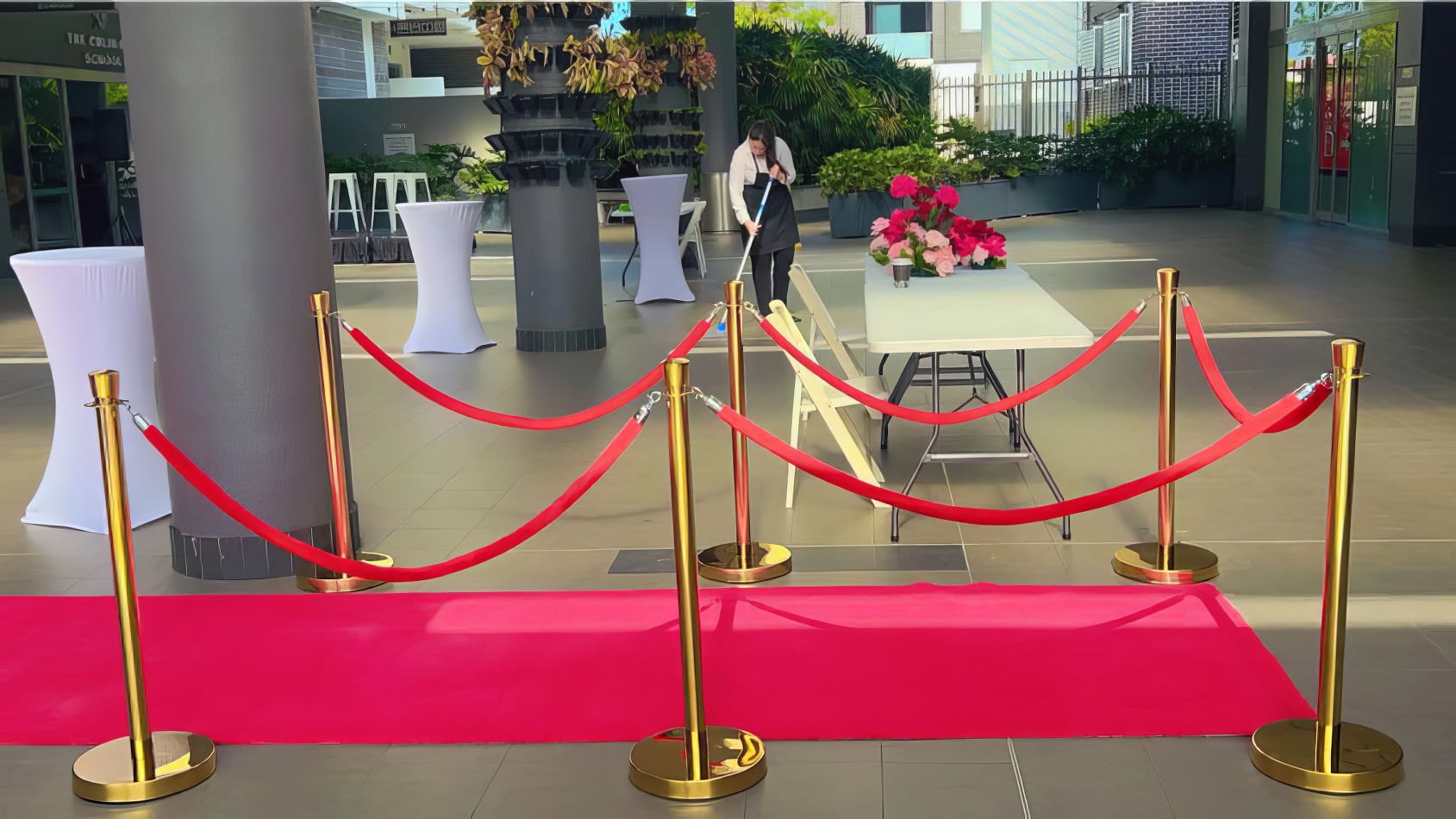 A 6m red carpet with gold ropes in front of a table.