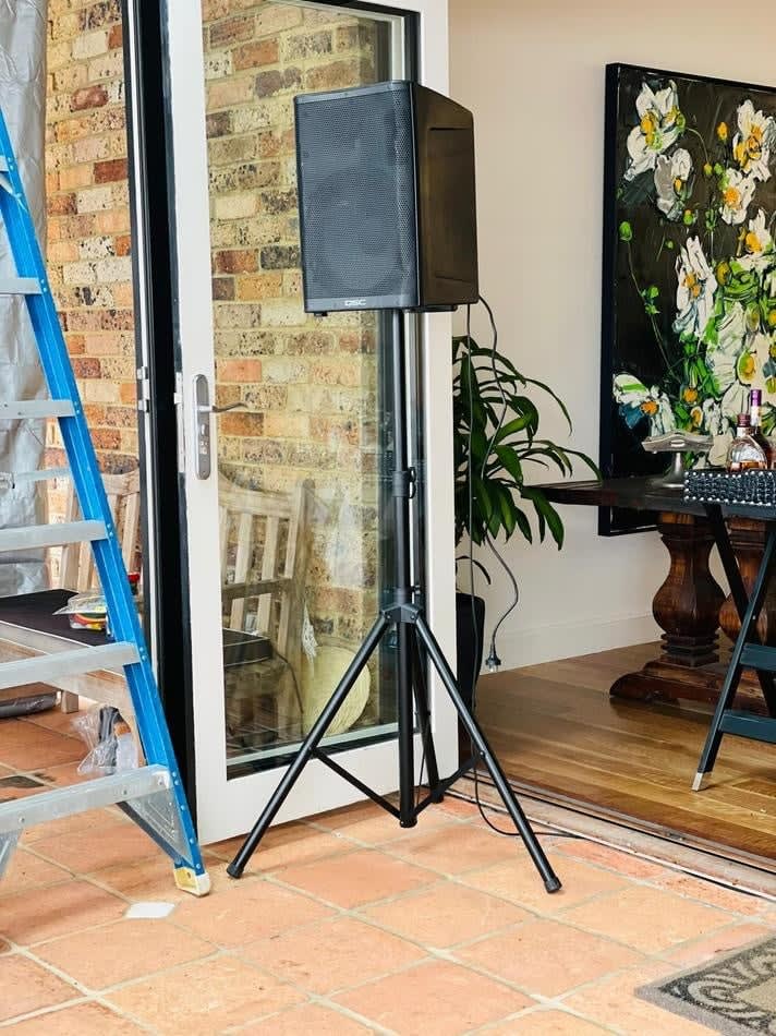 A speaker stands beside a hire door.