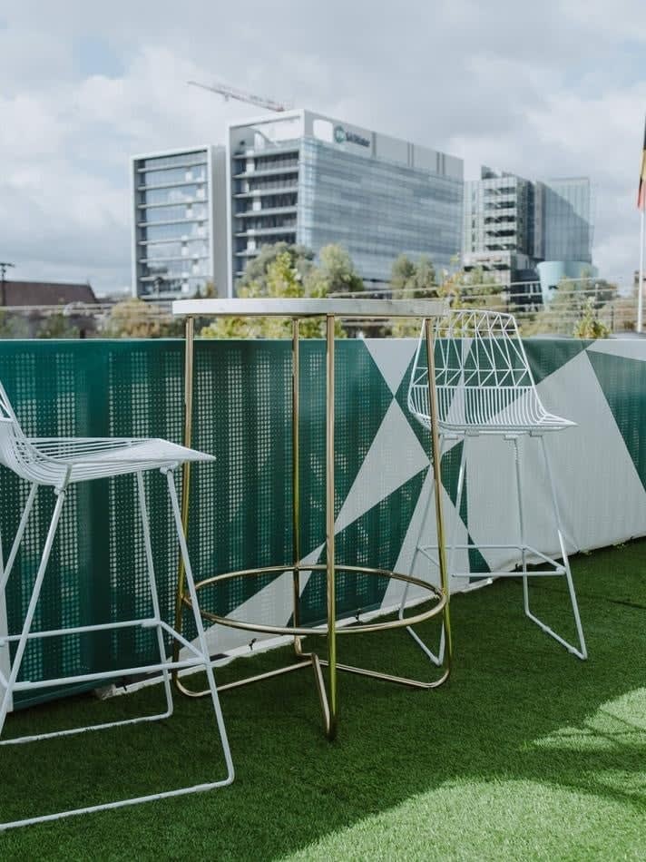 A white table on a green grassy area.