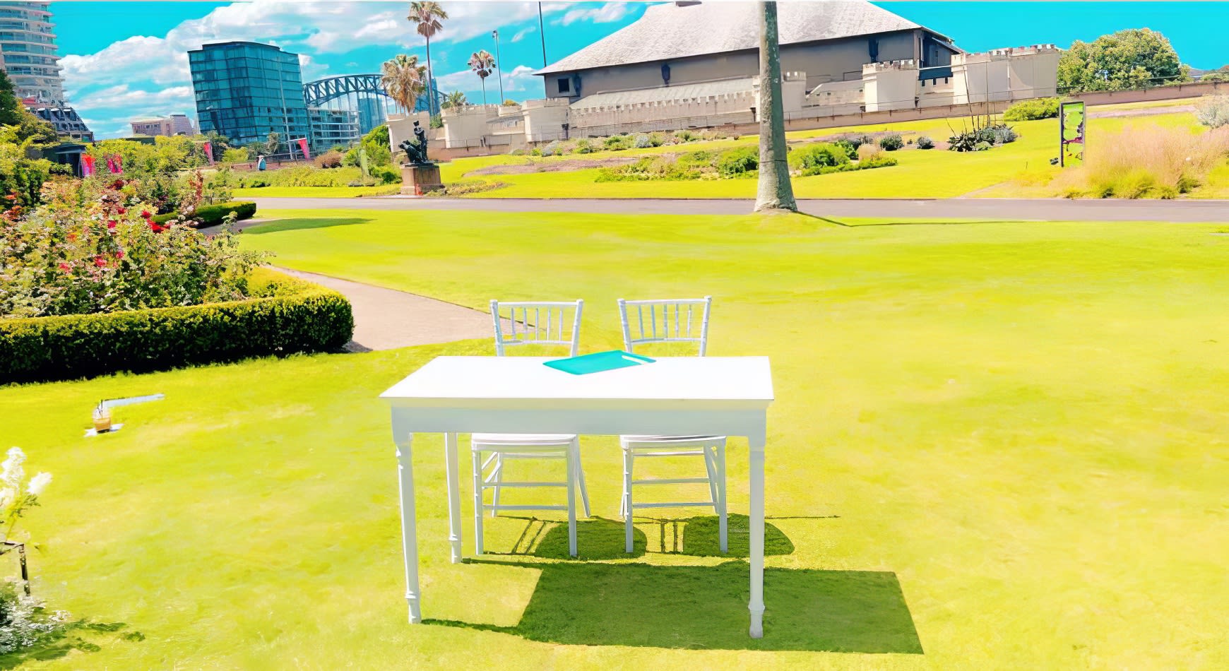 A white vintage style table in a grassy area.