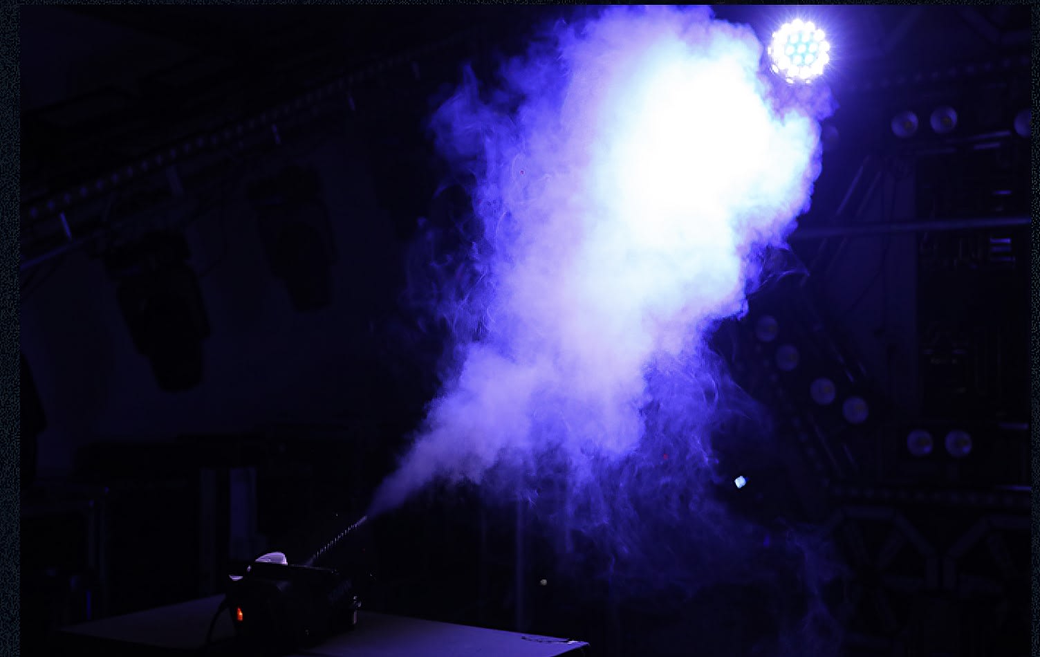 Smoke Machine Hire: A smoke machine is being used in a dark room.