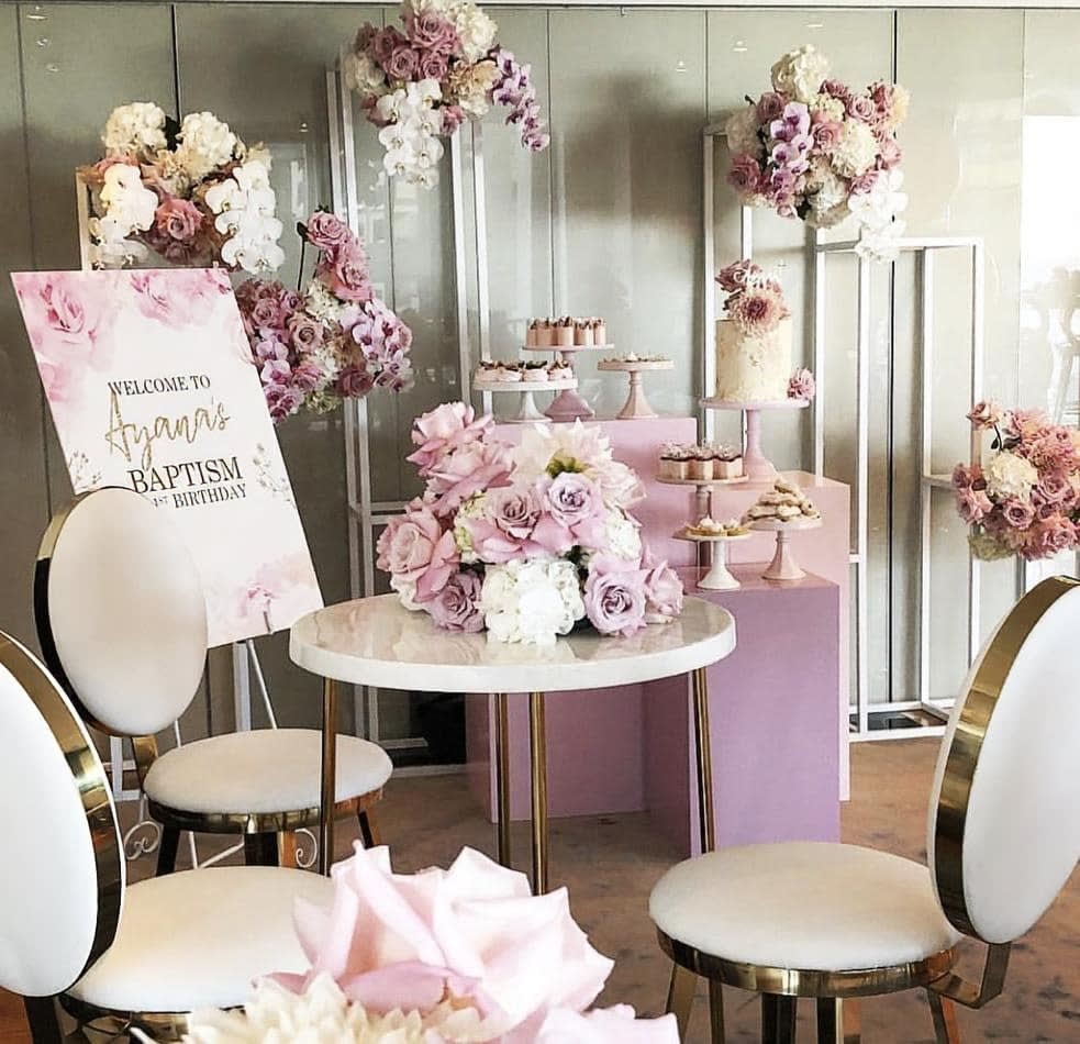 A pink bridal shower set up in a room, featuring the hire of three square plinths in a coordinating white color for added elegance.