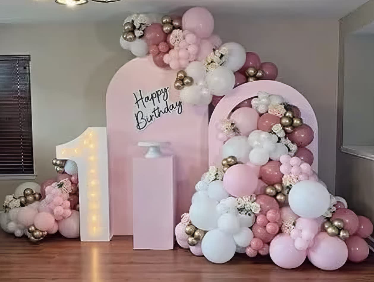 A pink balloon backdrop for a birthday party.