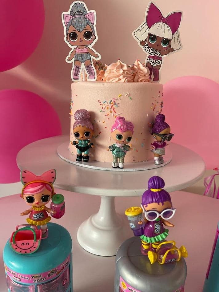 A cake with lol dolls on top of it displayed on a White Metal Cake Stand Hire.