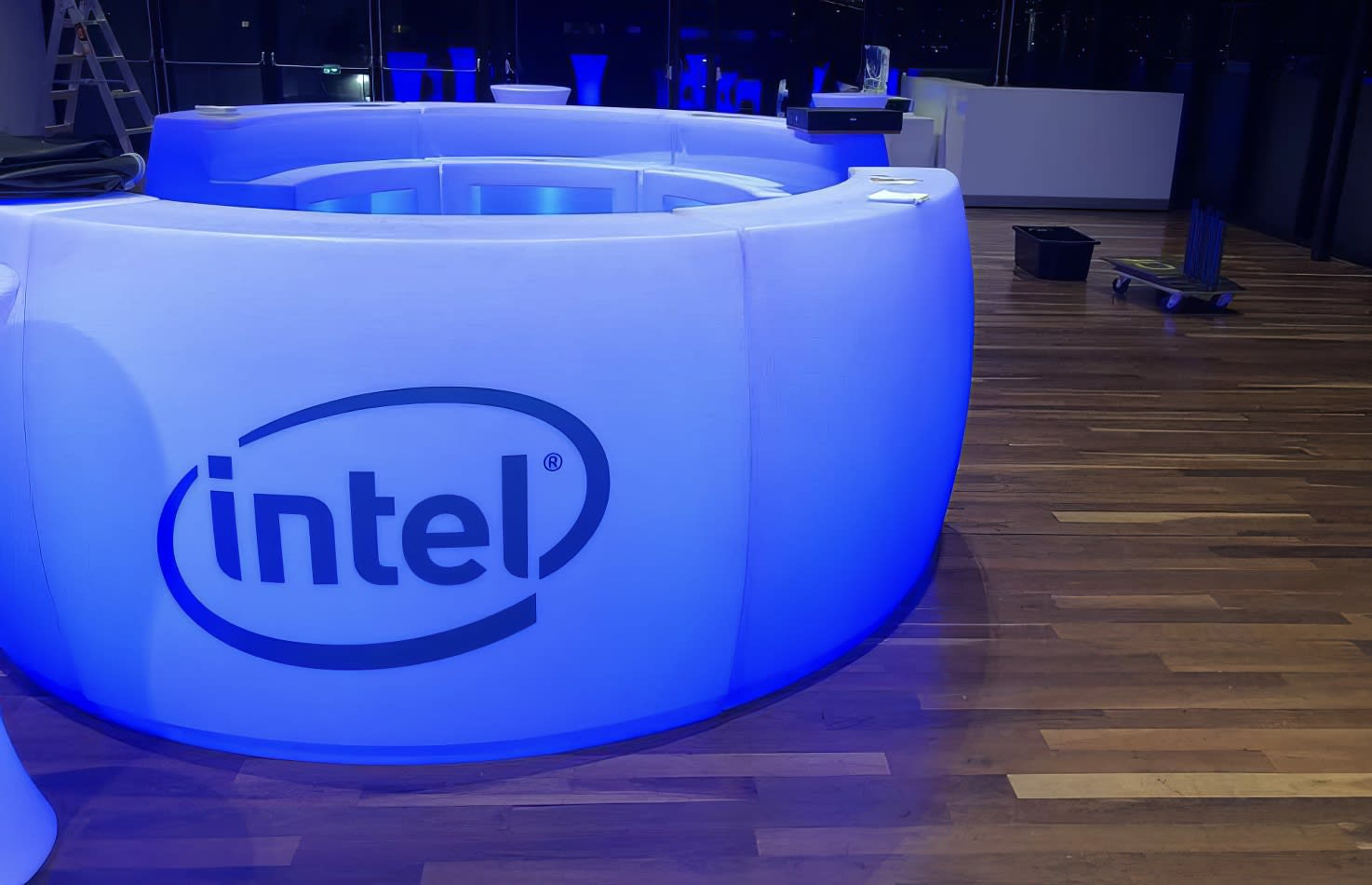 The intel logo is illuminated on a table.