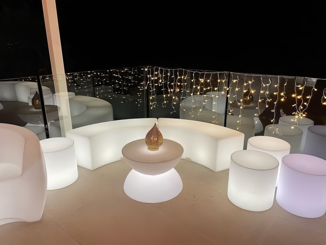 A white table and chairs with glow lights on them.