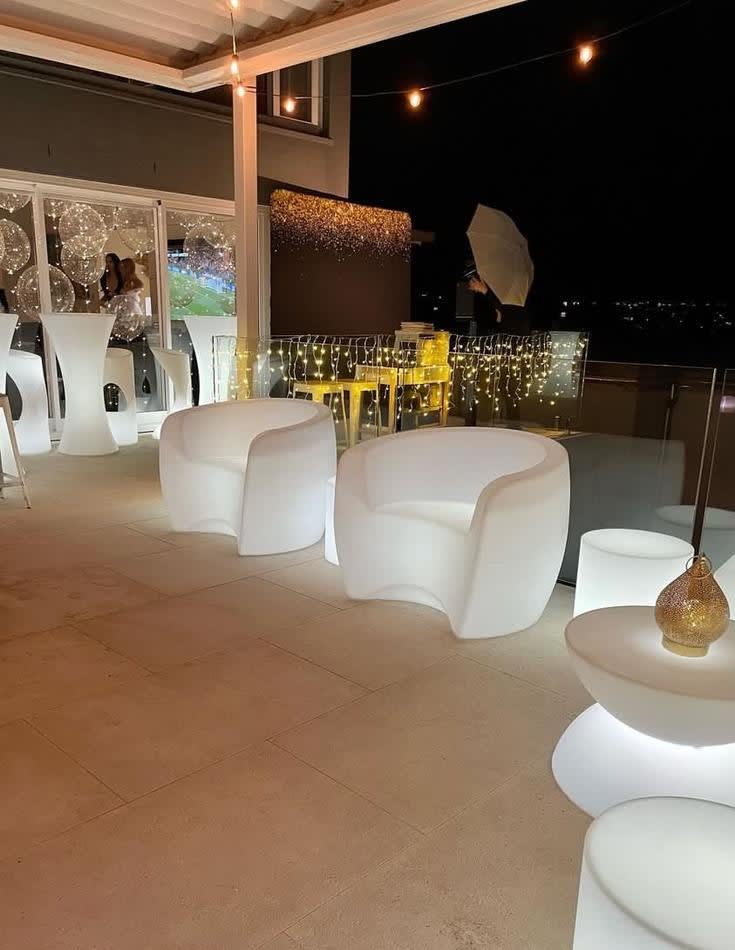 Rent a white outdoor lounge area with white chairs and tables for your next event, provided by Glow Couch Hire.