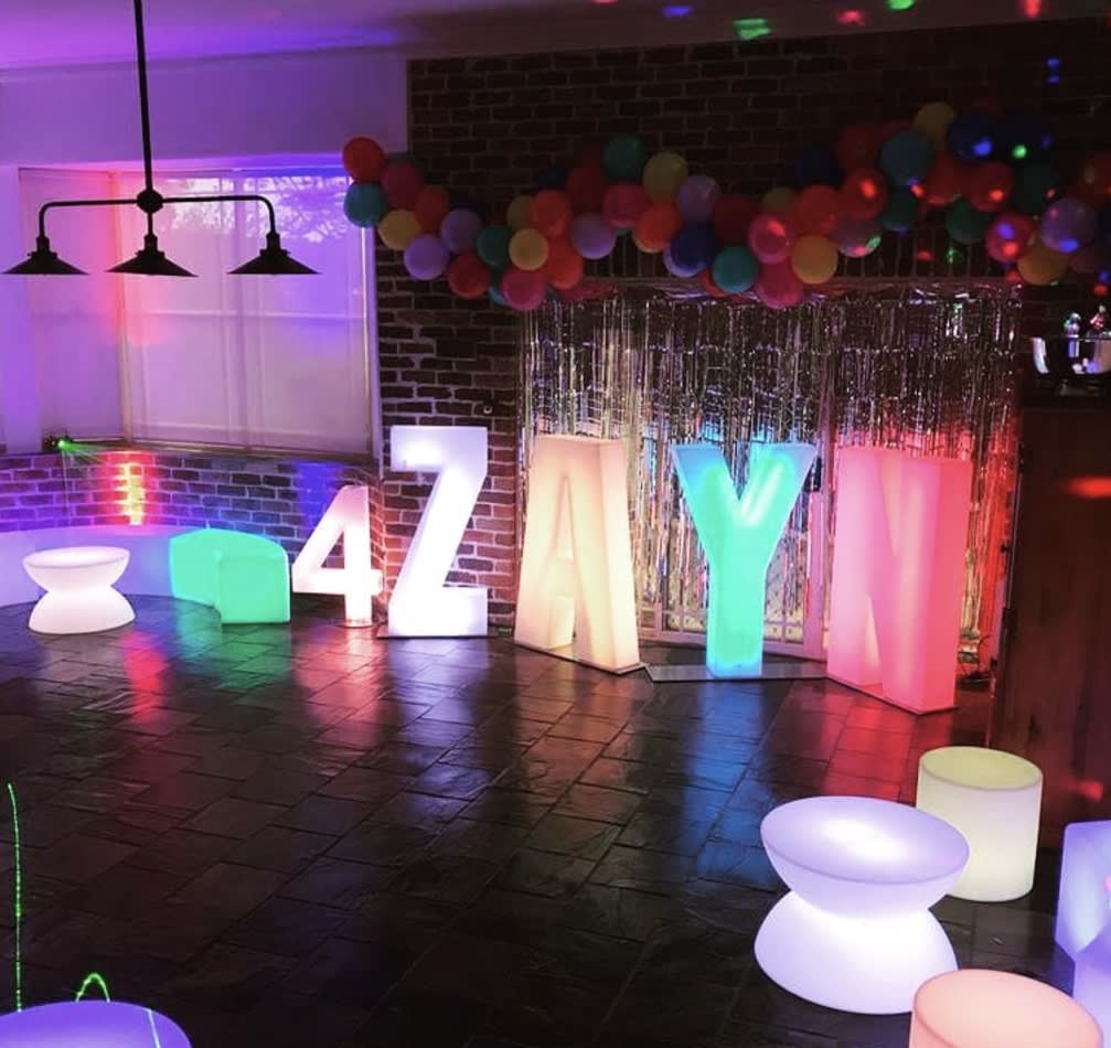 A vibrant birthday party with colorful balloons and glow cylinder seat hire options for added charm.