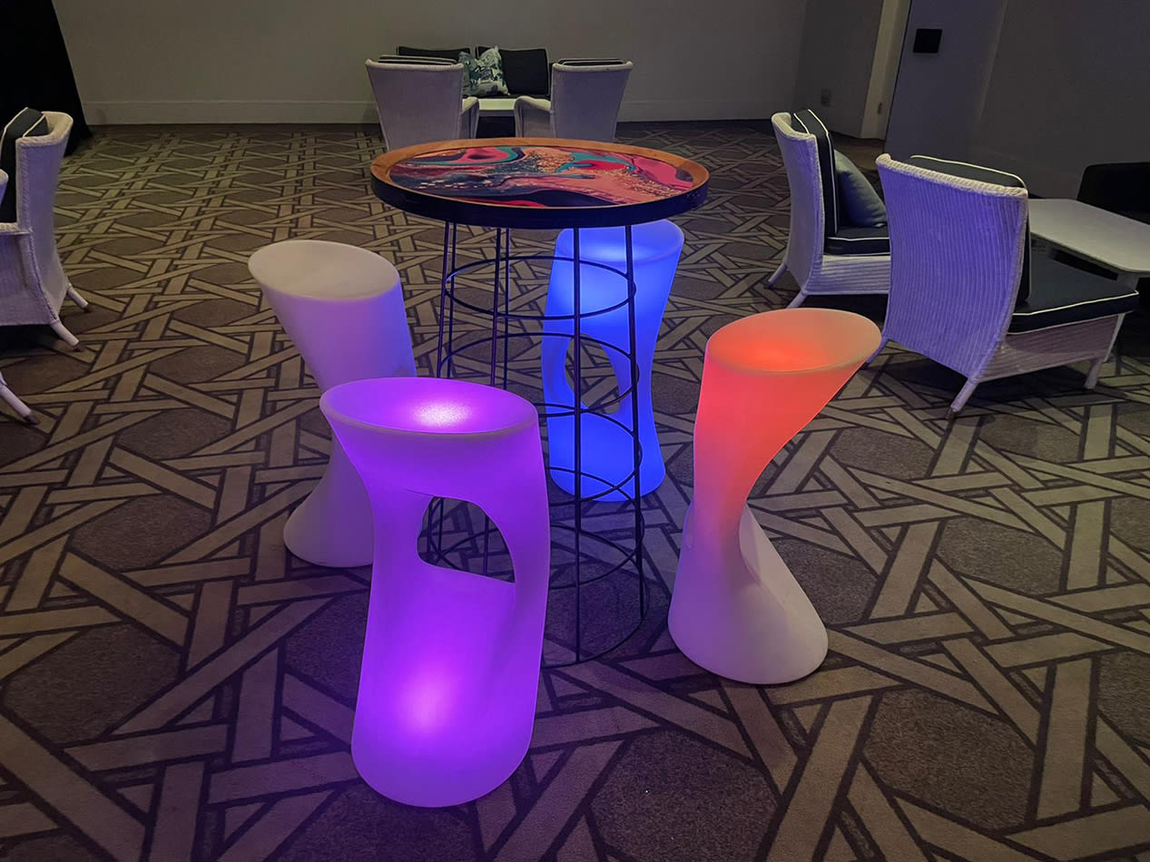 A set of colorful Glow Stool Hire in a conference room.