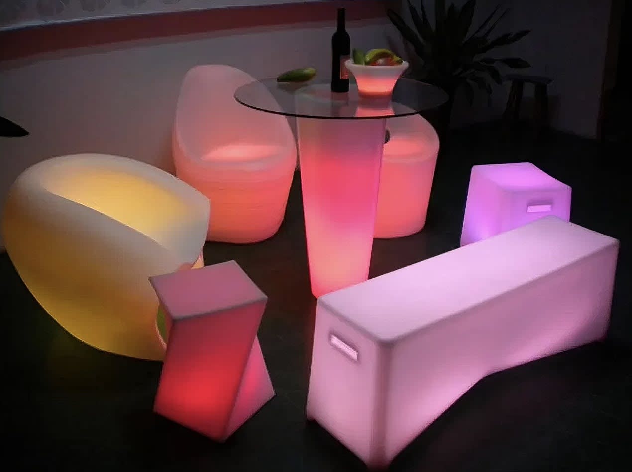 Twisted Cube - a set of colorful lighted furniture in a dark room.