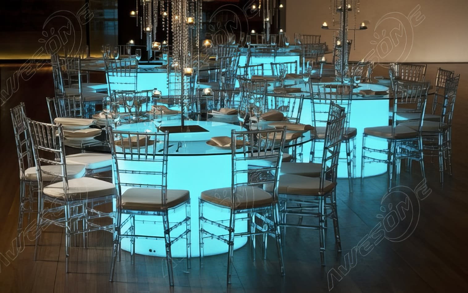 A Round Glow Banquet Table with blue lights in the middle of a room.