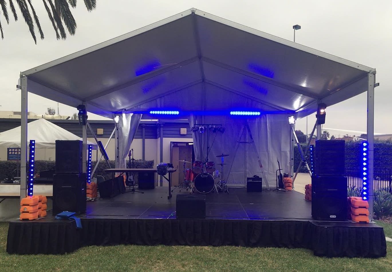 An outdoor event stage set up featuring intelligent light hire.