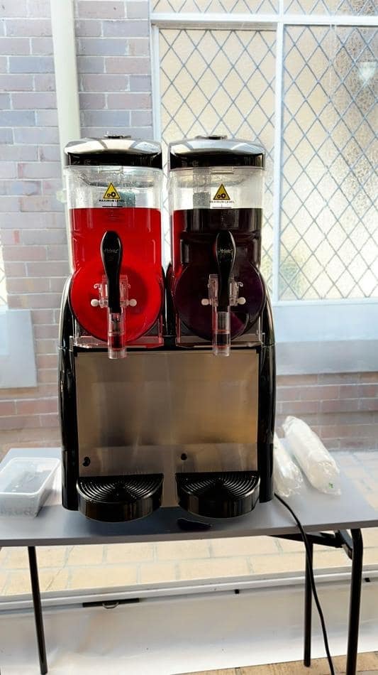 Two Slushie Machines on a table in front of a window, serving 120 drinks.