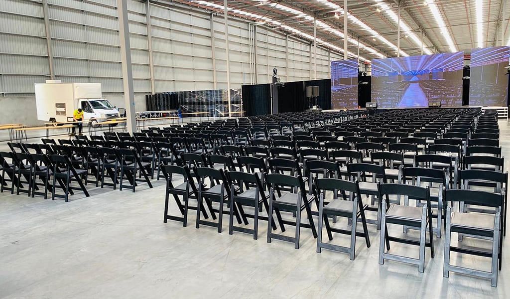 Black padded foldable chairs arranged for a conference