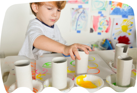 A young boy playing with home-made paints