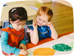 Two young girls inclusively playing together and painting