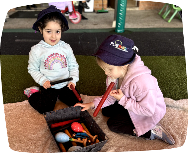 Two girls happily playing together at Playbright Marayong