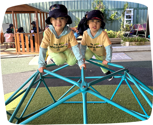 Two happy children climbing and playing at Playbright Marayong