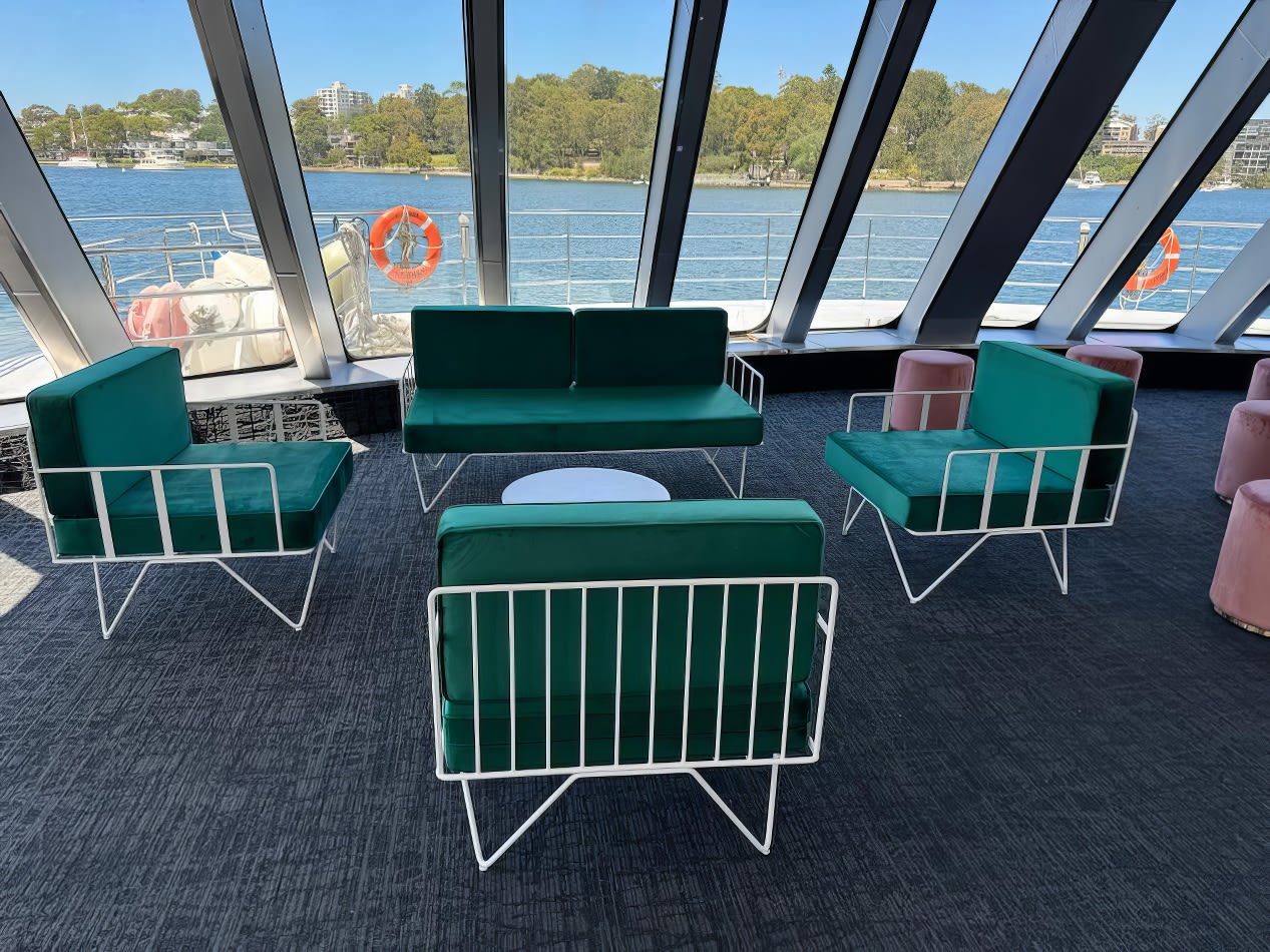 A green ivy wire sofa lounge set inside of a boat