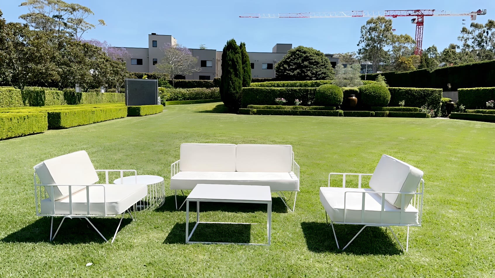 White sofa lounges on a beautiful green lawn