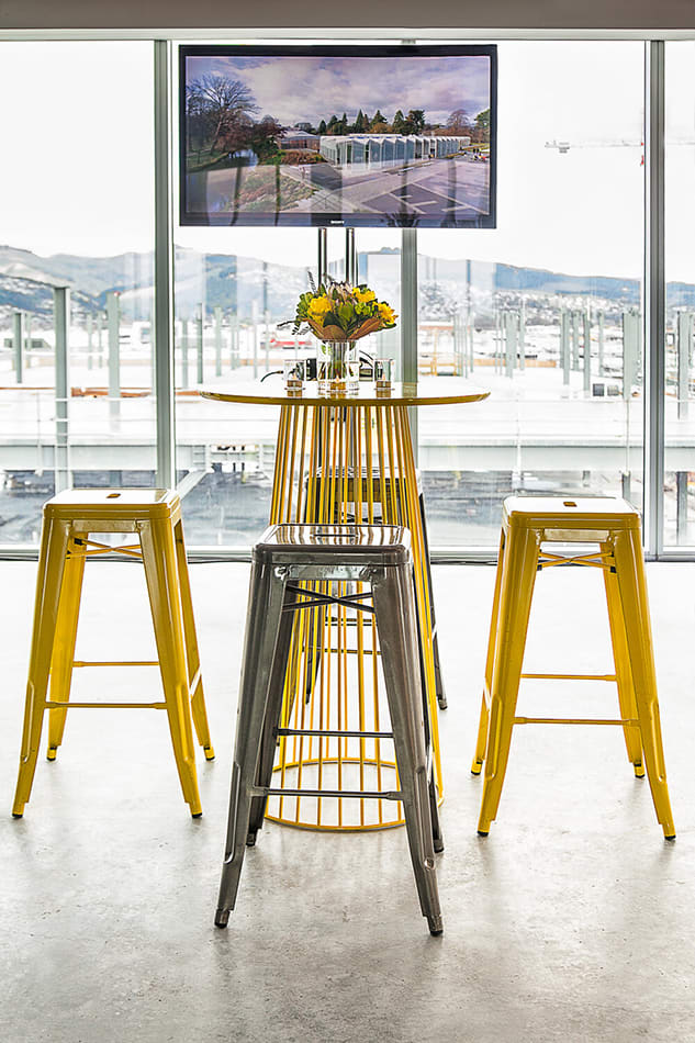 A yellow wire cocked table table inside of a bar area