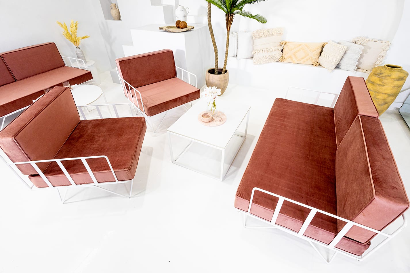 White Rectangular Coffee Table next to a red velvet lounge